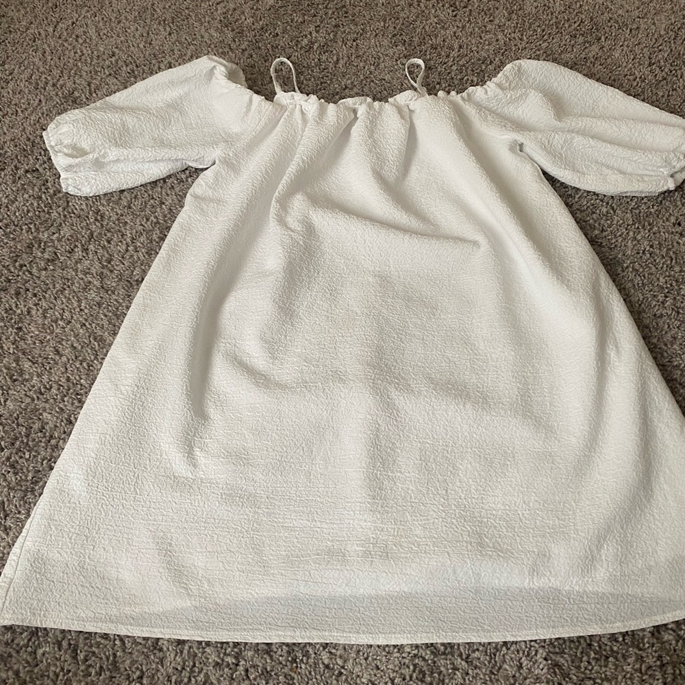 All white off the shoulder dress, with straps.